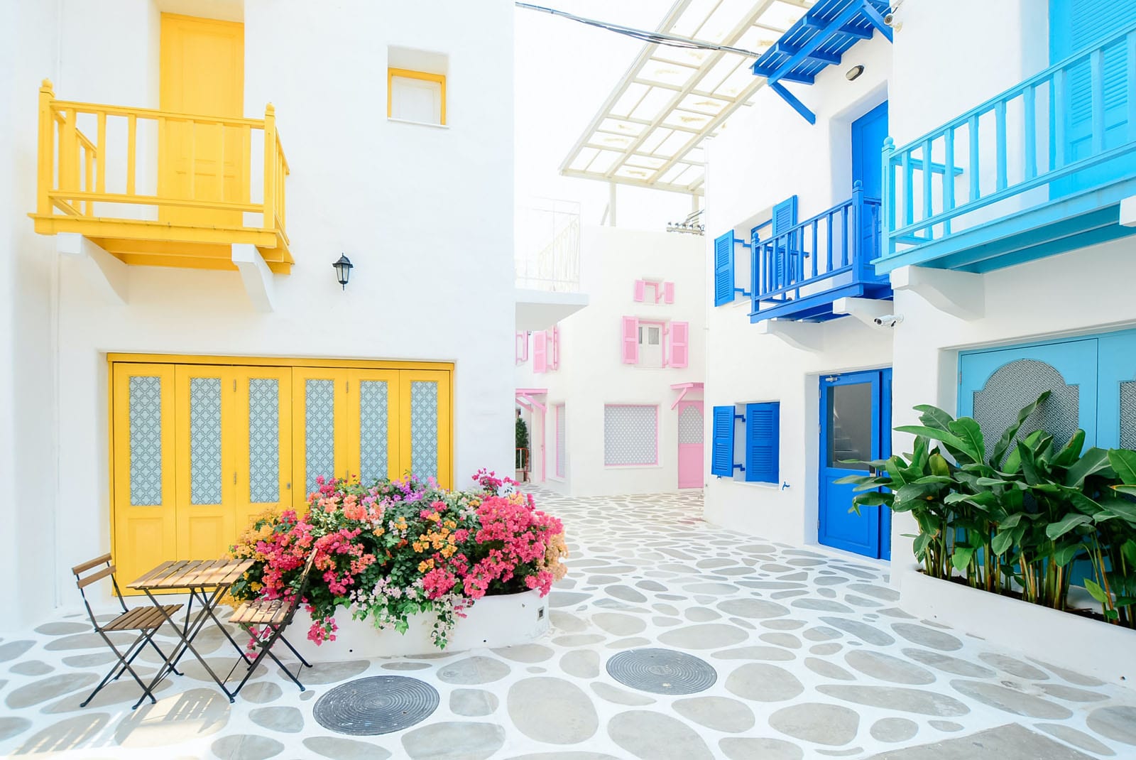 Brightly coloured courtyard with table and chairs