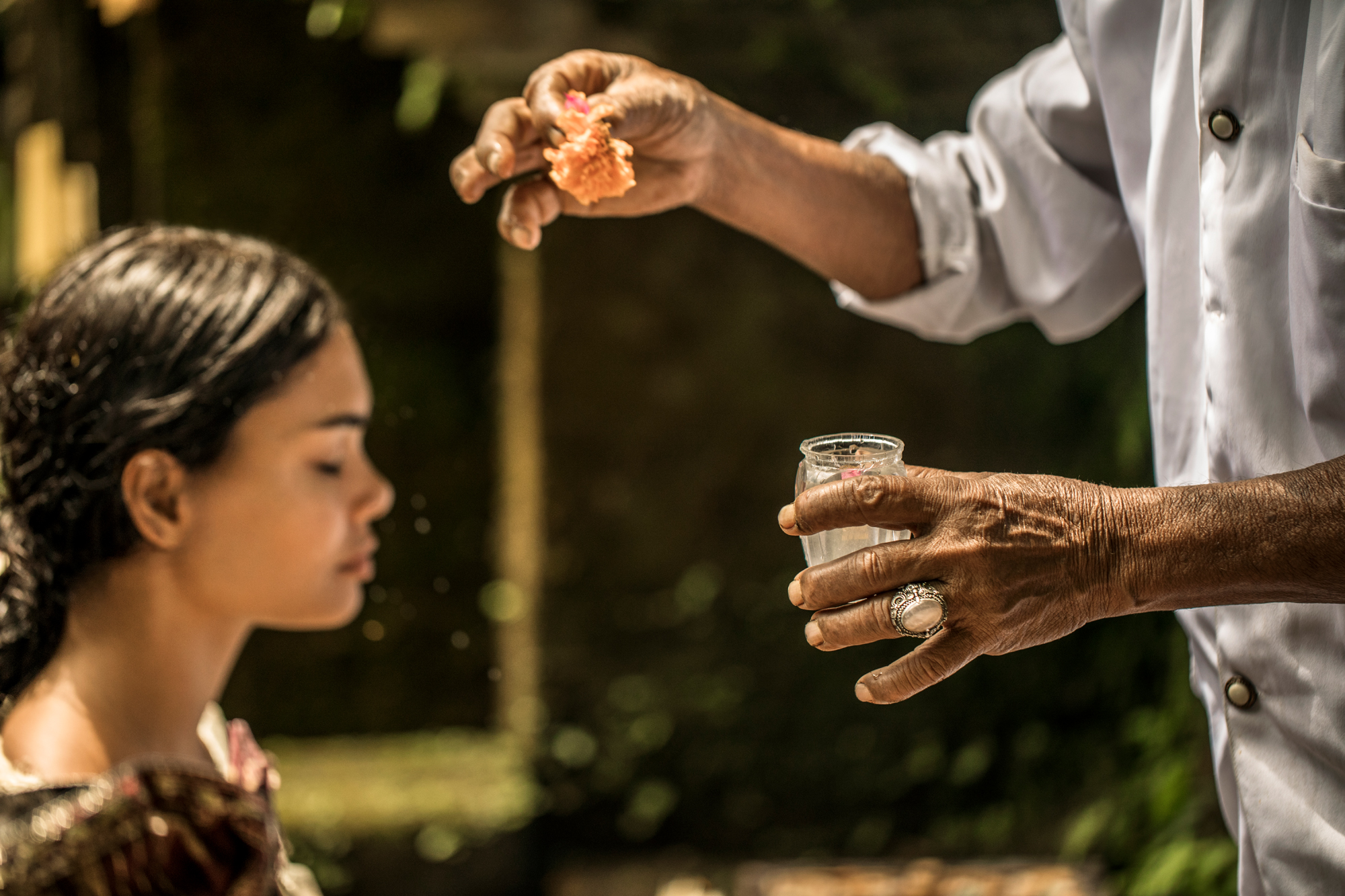 mm980_COMO_Shambhala_Estate_2018 A practitioner performs traditional cupping therapy, preparing glass cups for placement in a serene wellness setting